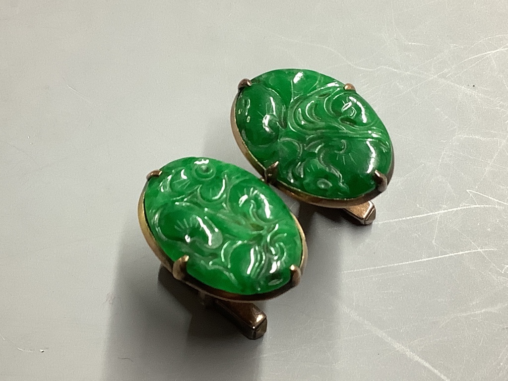 A pair of Chinese 14K gold and green jade oval cufflinks